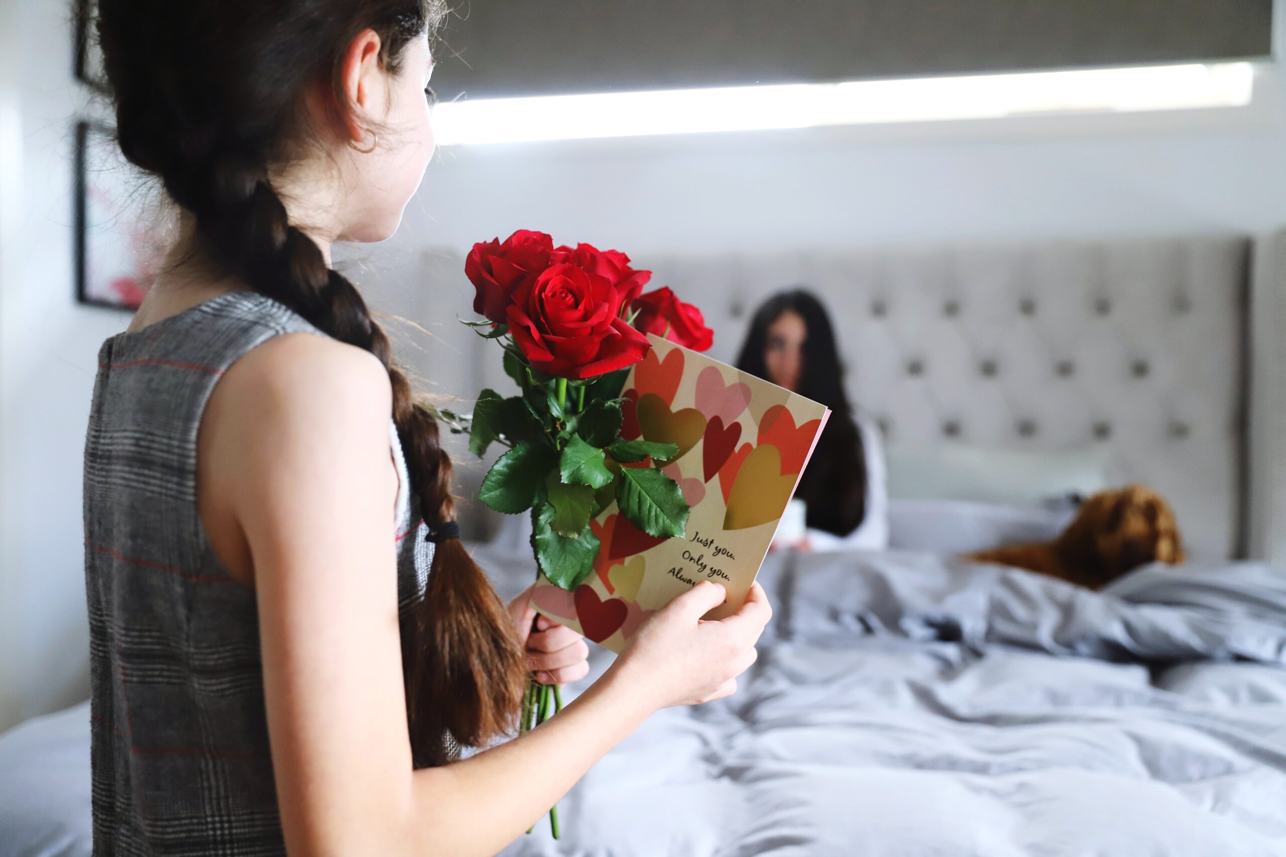  girl giving cards and flowers to mum for mother’s day in Singapore 