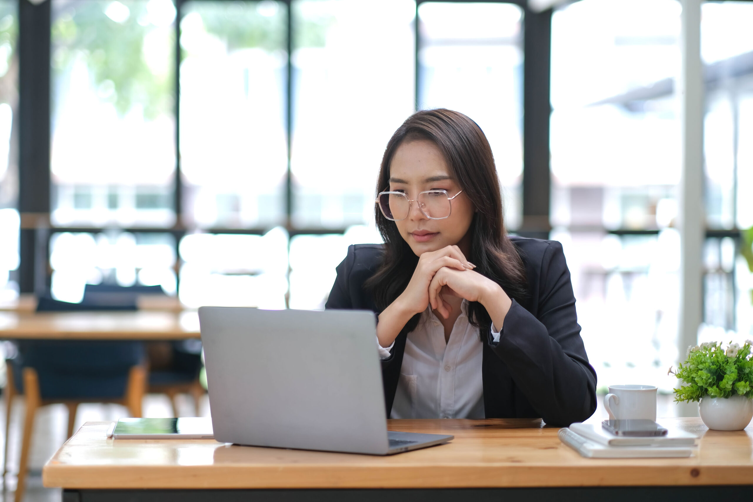 a businesswoman evaluating results of sco and seo strategies